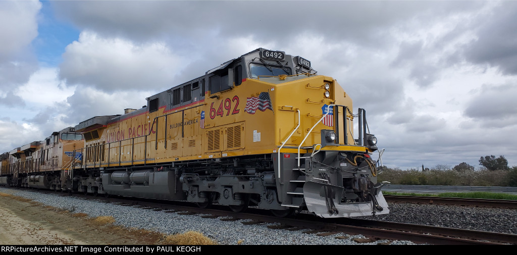 A Brand New UP C44ACM with The Brand New Union Pacific Railroad Paint Scheme sits in the Siding at Pixley,  California waiting to Pull Aoaded Grain Train South Bound